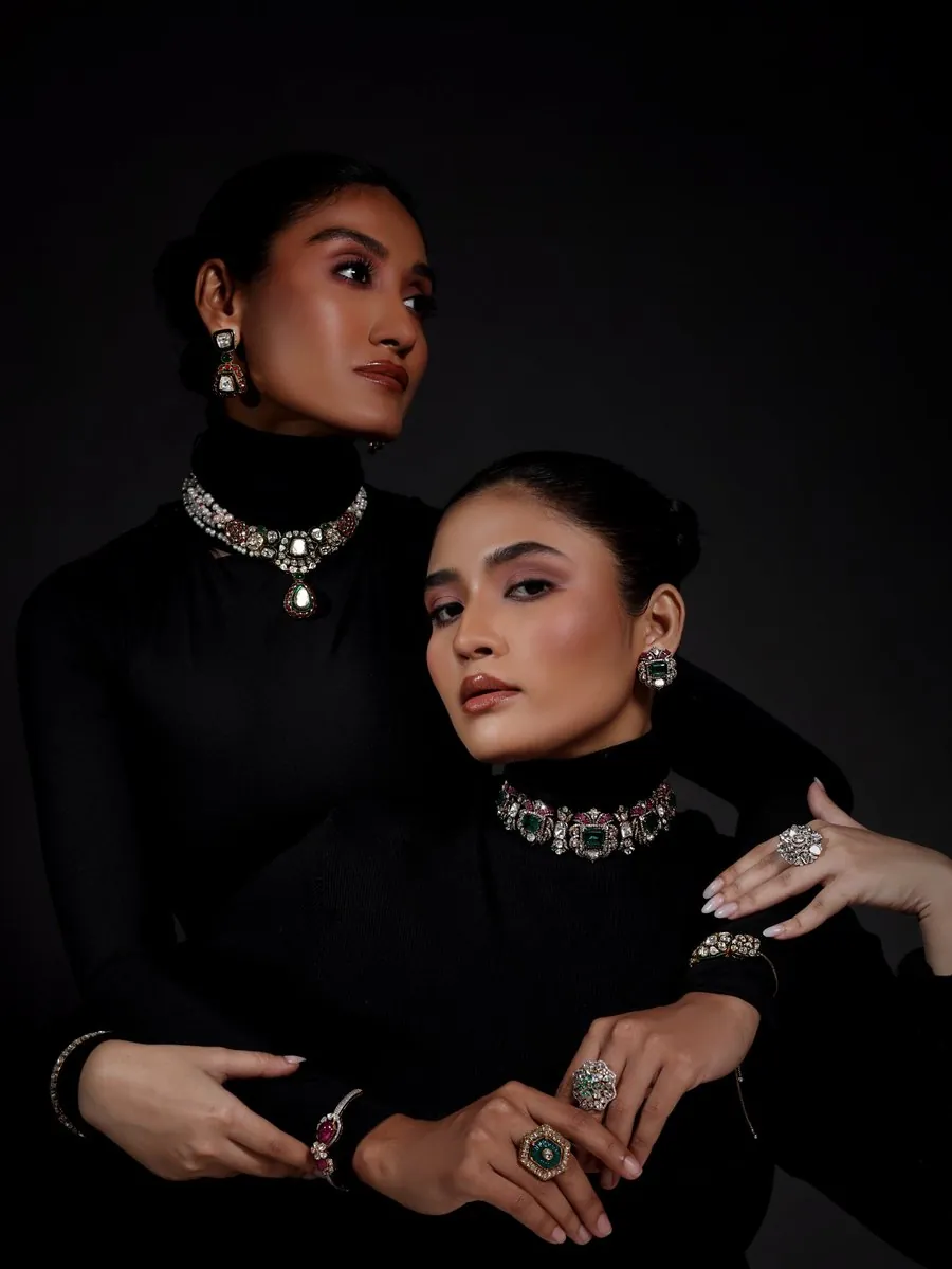 Two models in black wearing statement jewellery