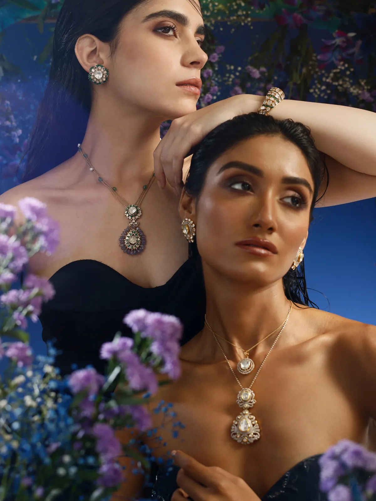 Two models in a blue floral set wearing polki necklaces and earrings