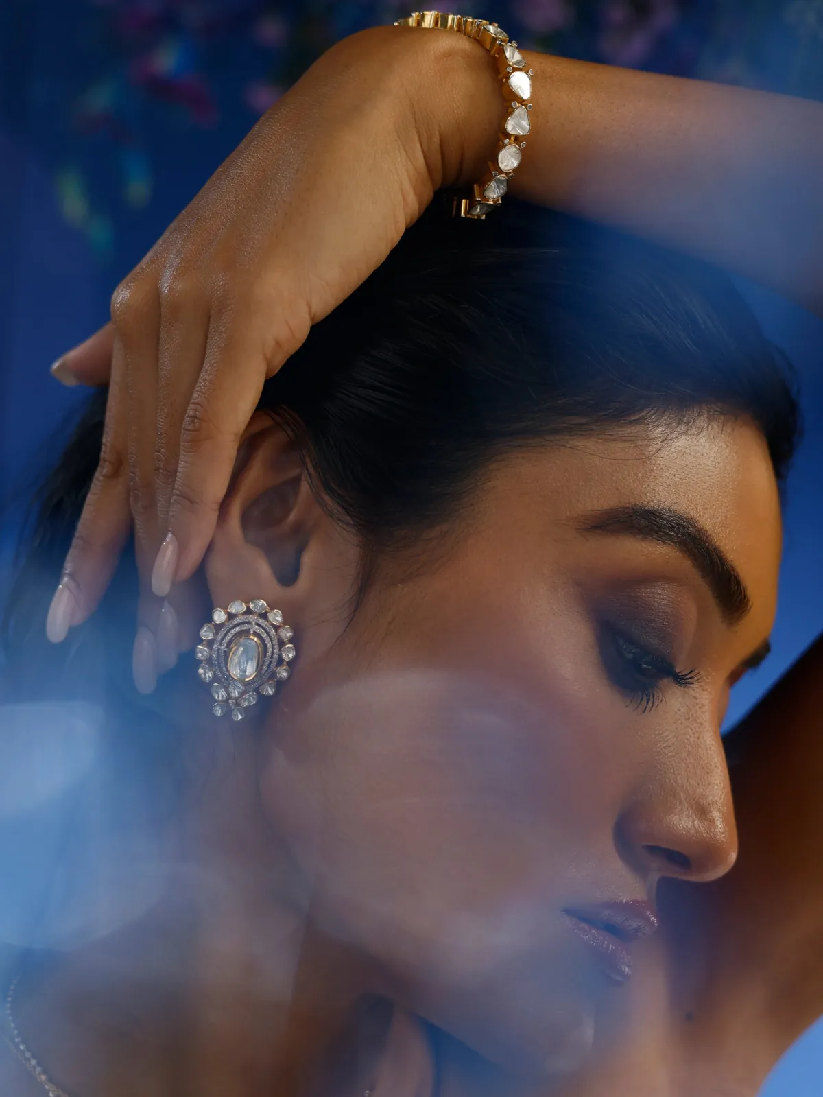 Close-up of a polki earring and bracelet on a model